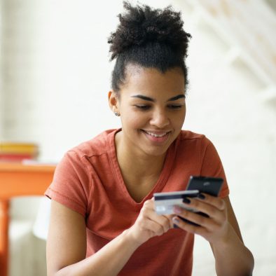 Woman on phone with a credit card