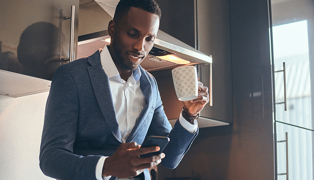 Man on mobile phone with coffee